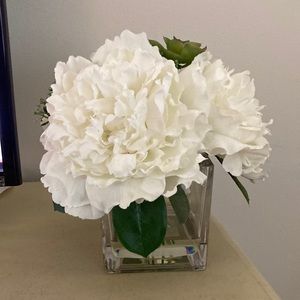 Faux floral bouquet in glass